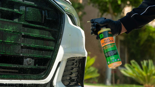 spraying 3d bug remover on bumper of white car