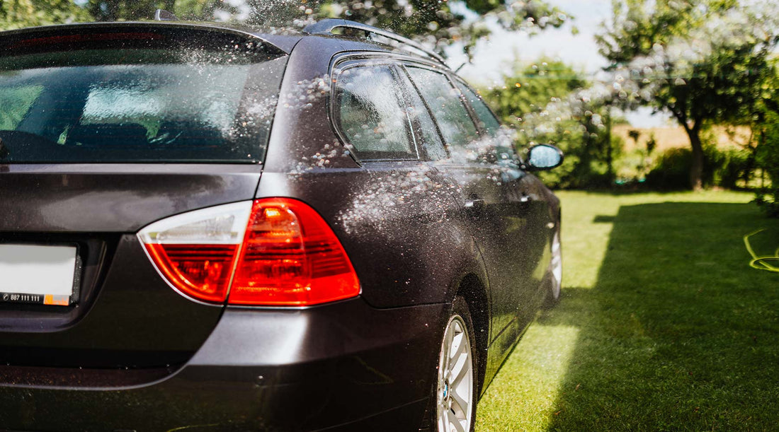 bmw station wagon on grass getting car wash in summer