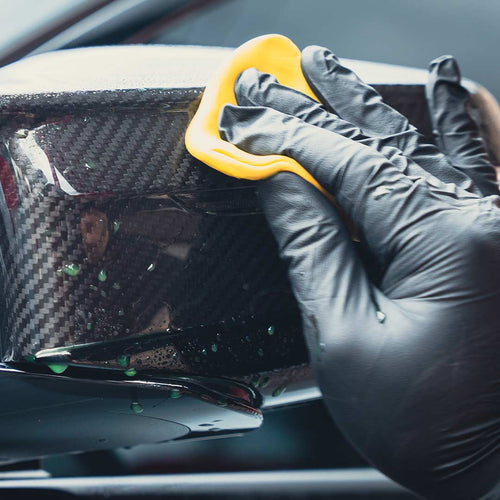 claying carbon fiber side mirror cap with yellow clay bar