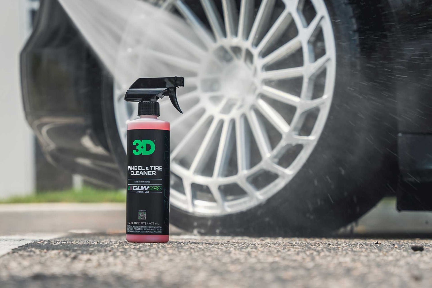 bottle of wheel and tire cleaner next to aftermarket wheel being cleaned