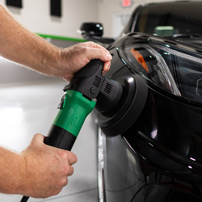 a person polishing a car